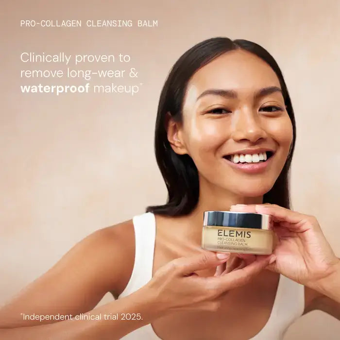 Woman holding a jar of Elemis Pro-Collagen Cleansing Balm against a beige background