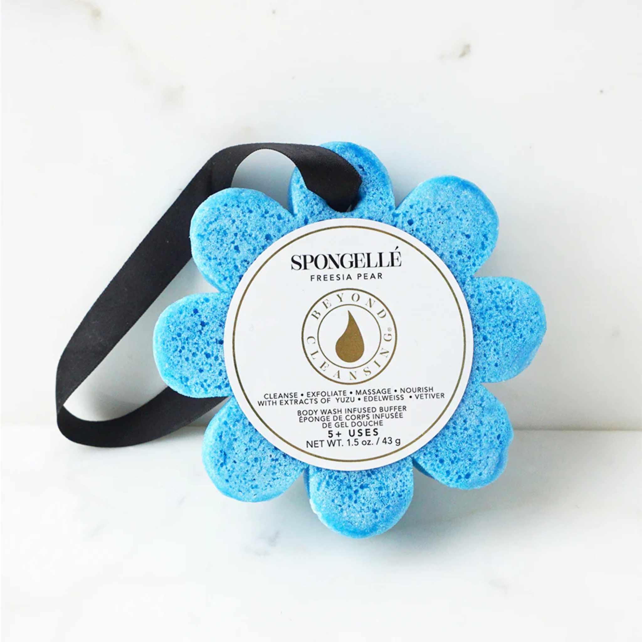 A blue flower shaped sponge against a white background with a label reading &