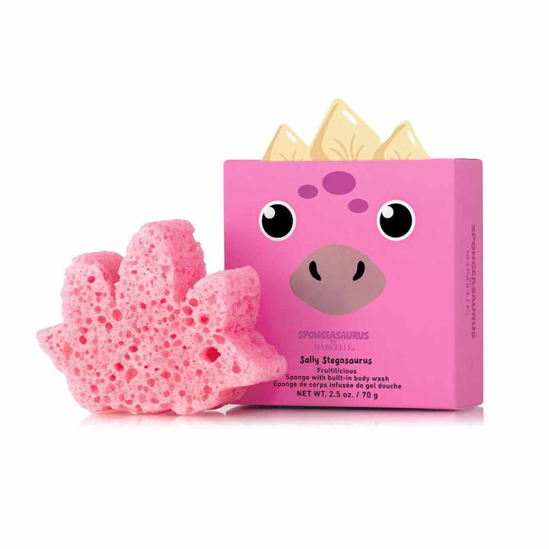A pink sponge shaped like a Stegosaurus with a box of Spongellé Spongeasaurus Collection in the background.