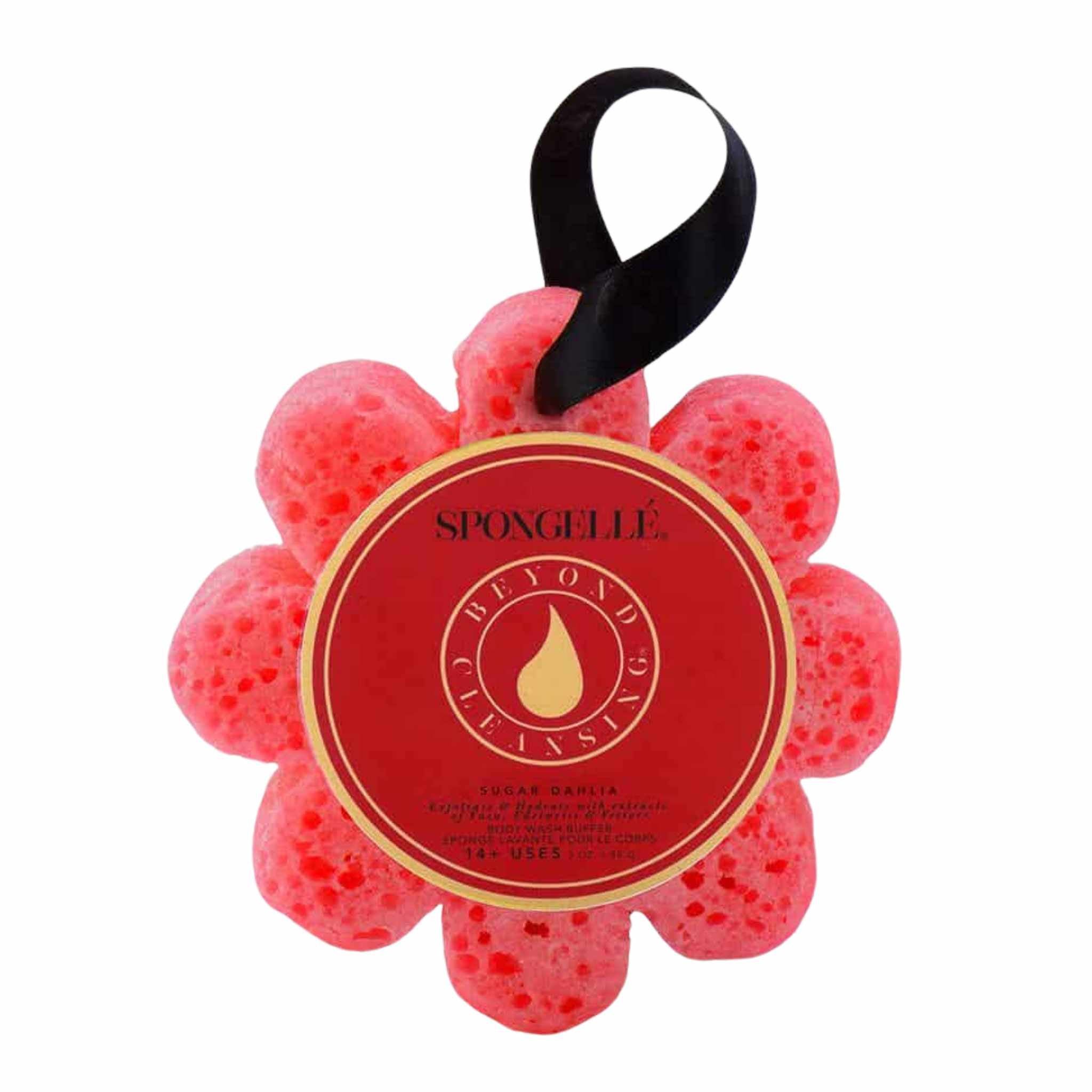 A red floral-shaped bath sponge with a black ribbon and a label in the center that reads &