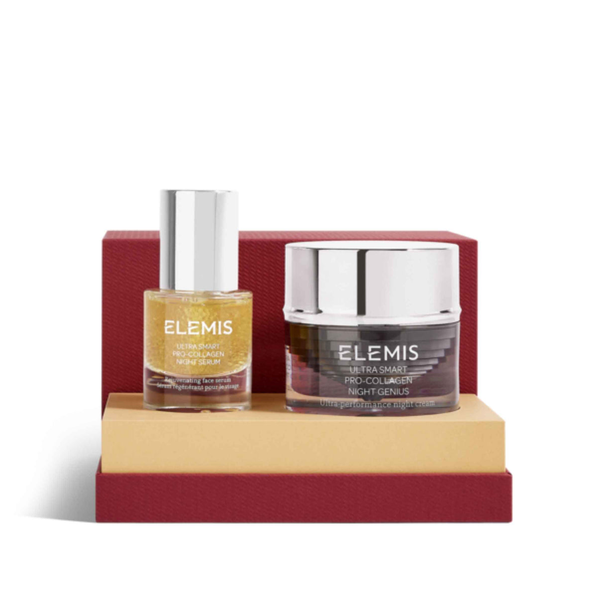 A skincare set by ELEMIS featuring a gold glitter body oil in a clear bottle with a silver cap, and a dark brown/protein collagen cream in a dark jar with a silver lid, displayed on a two-tiered beige and red stand against a white background.