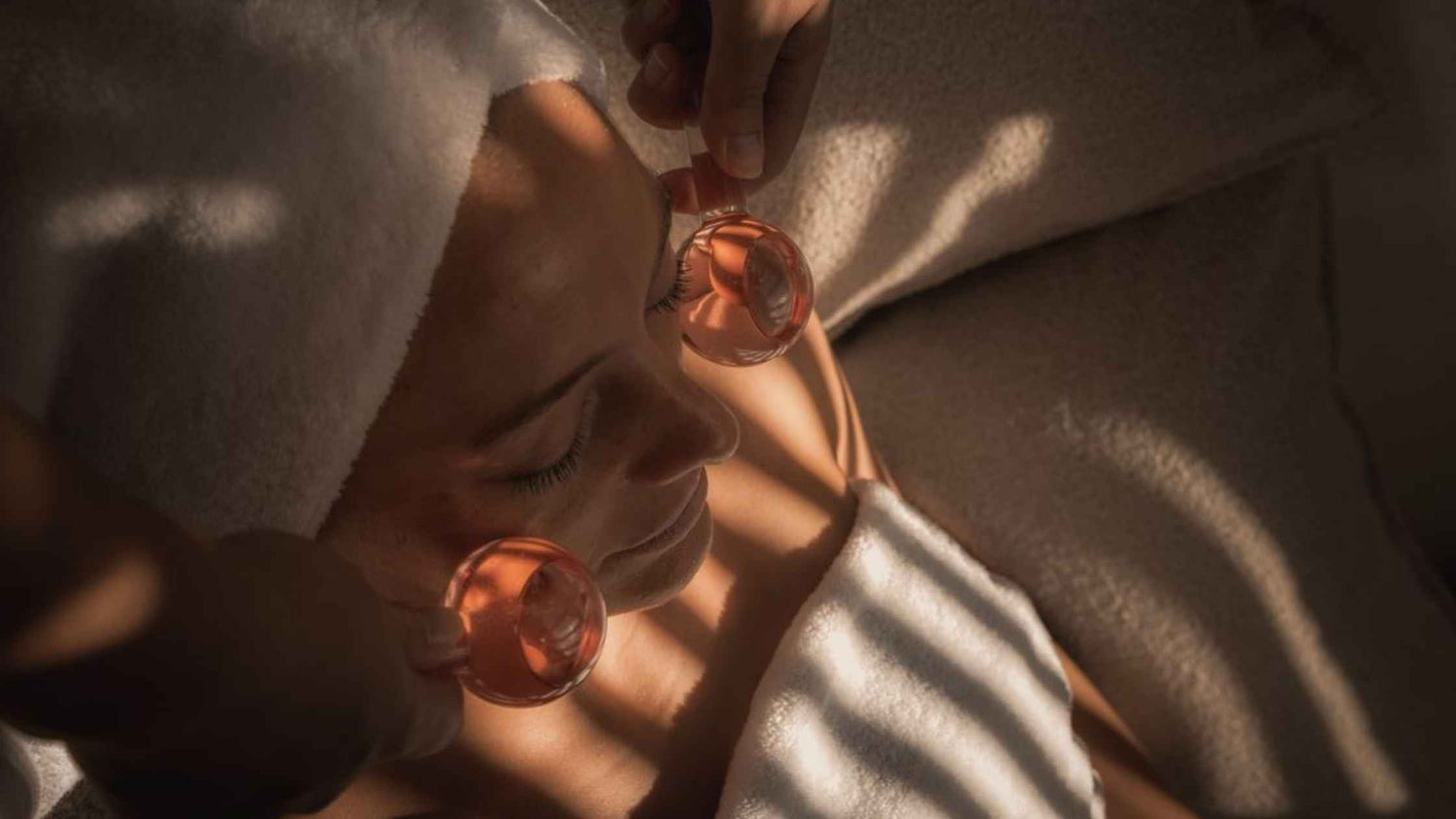 a woman receiving a facial with rollers