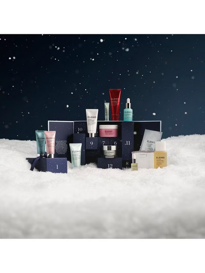 Collection of skincare products in front of a dark snowy background