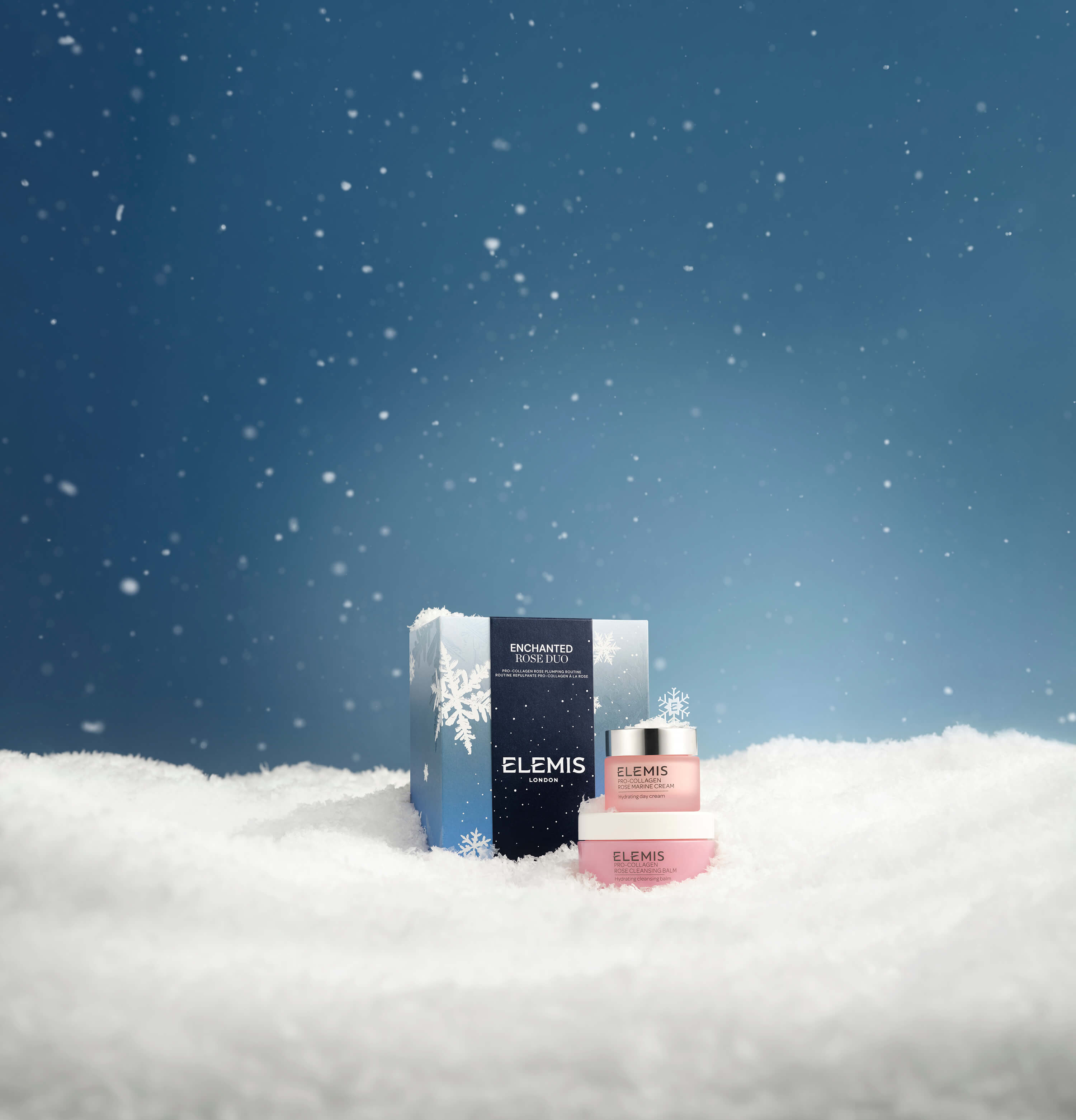 ELEMIS skincare products in the snow with a blue sky background