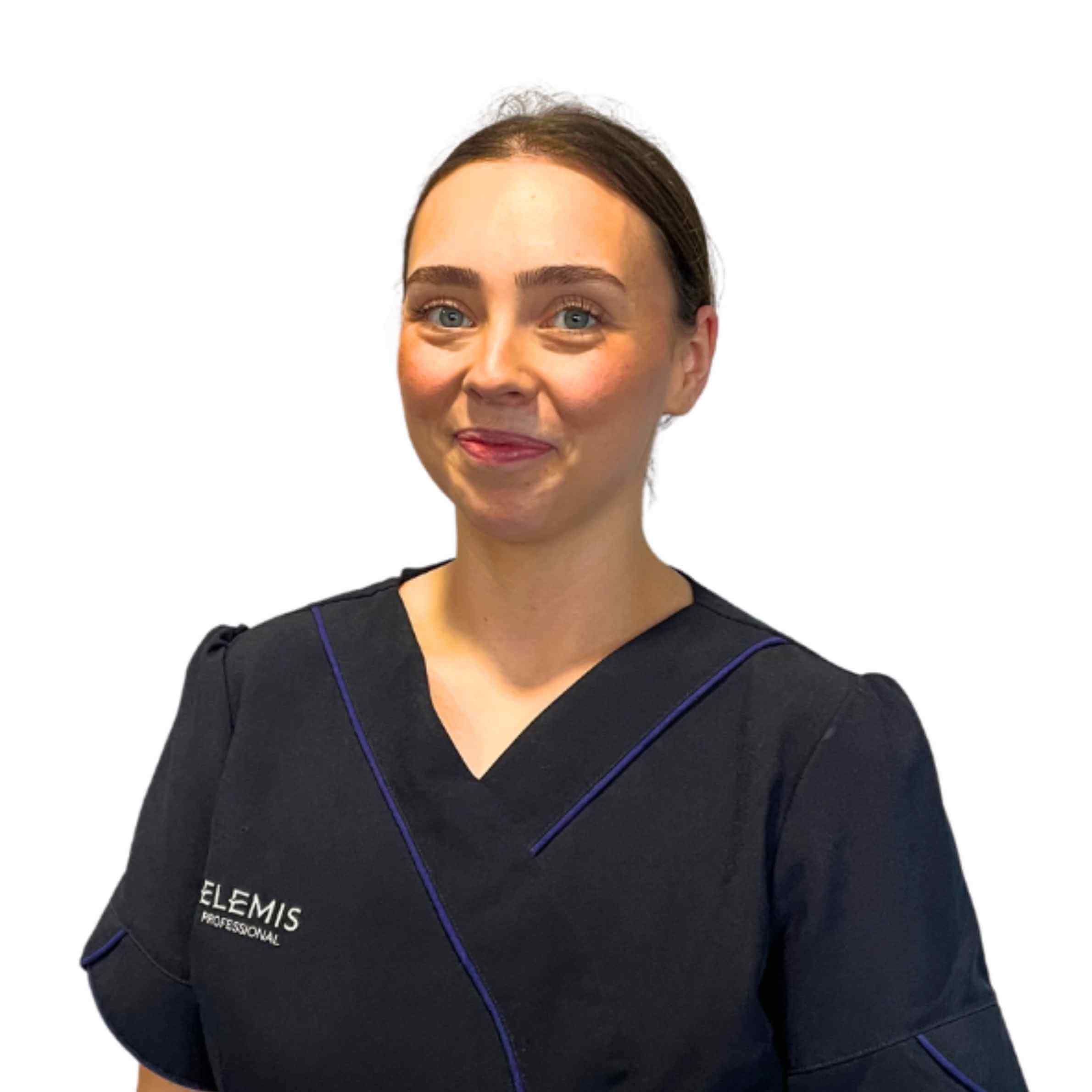 Woman wearing a blackElemis scrub top on a white background