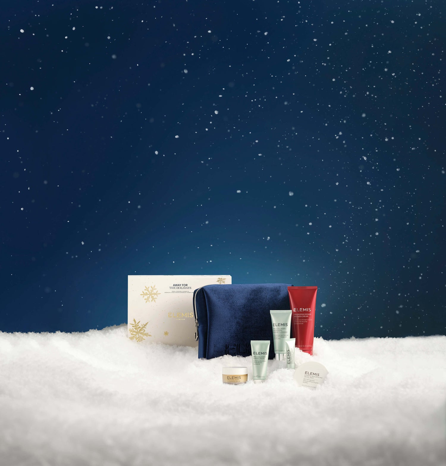 Cosmetic products on a snowy surface with a starry night sky background