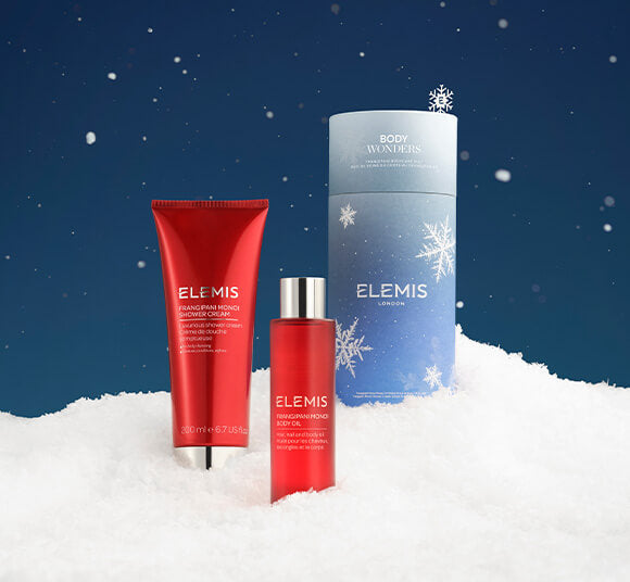 Elemis skincare products on a snowy background with snowflakes.
