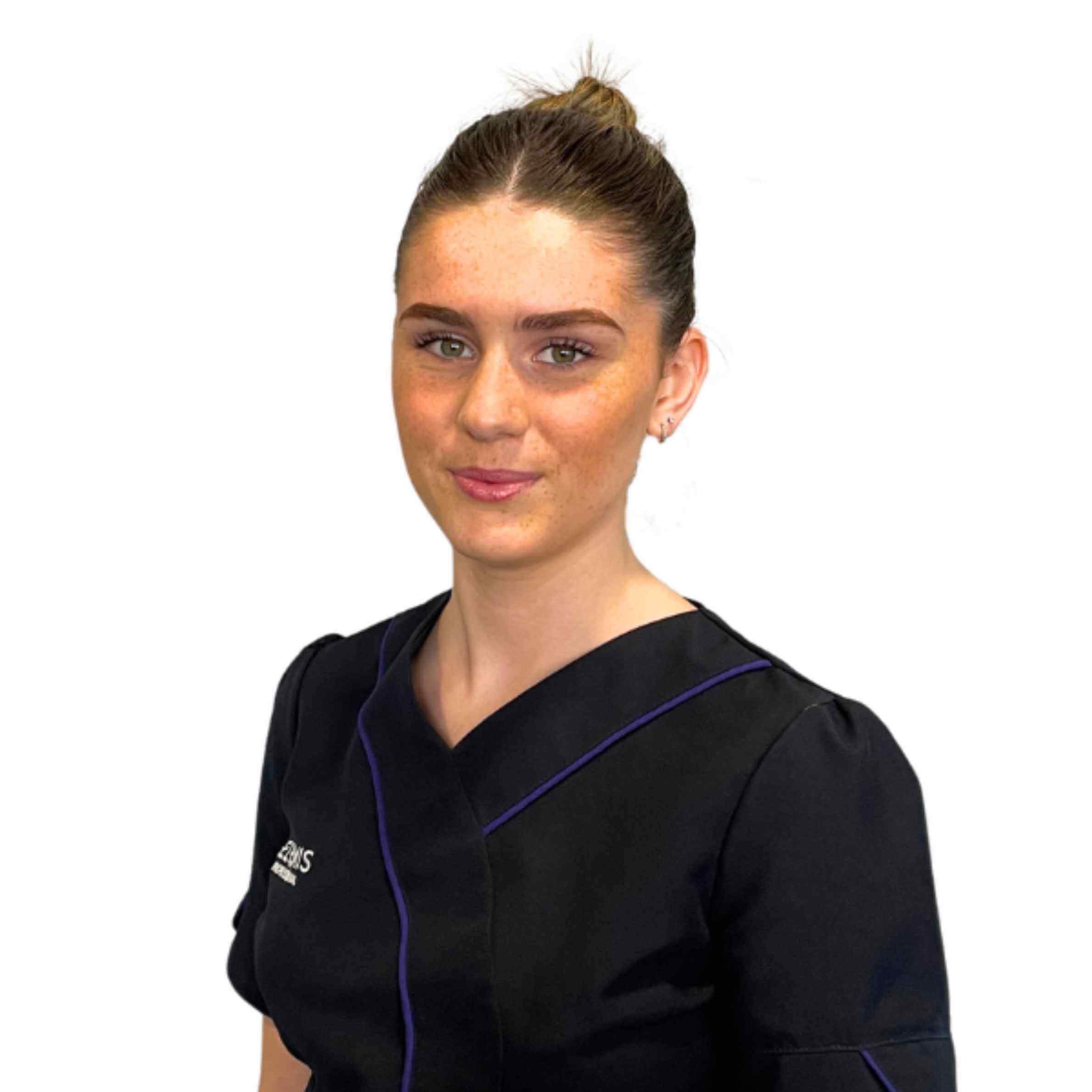 Woman wearing a black scrub top with a visible brand logo on a white background