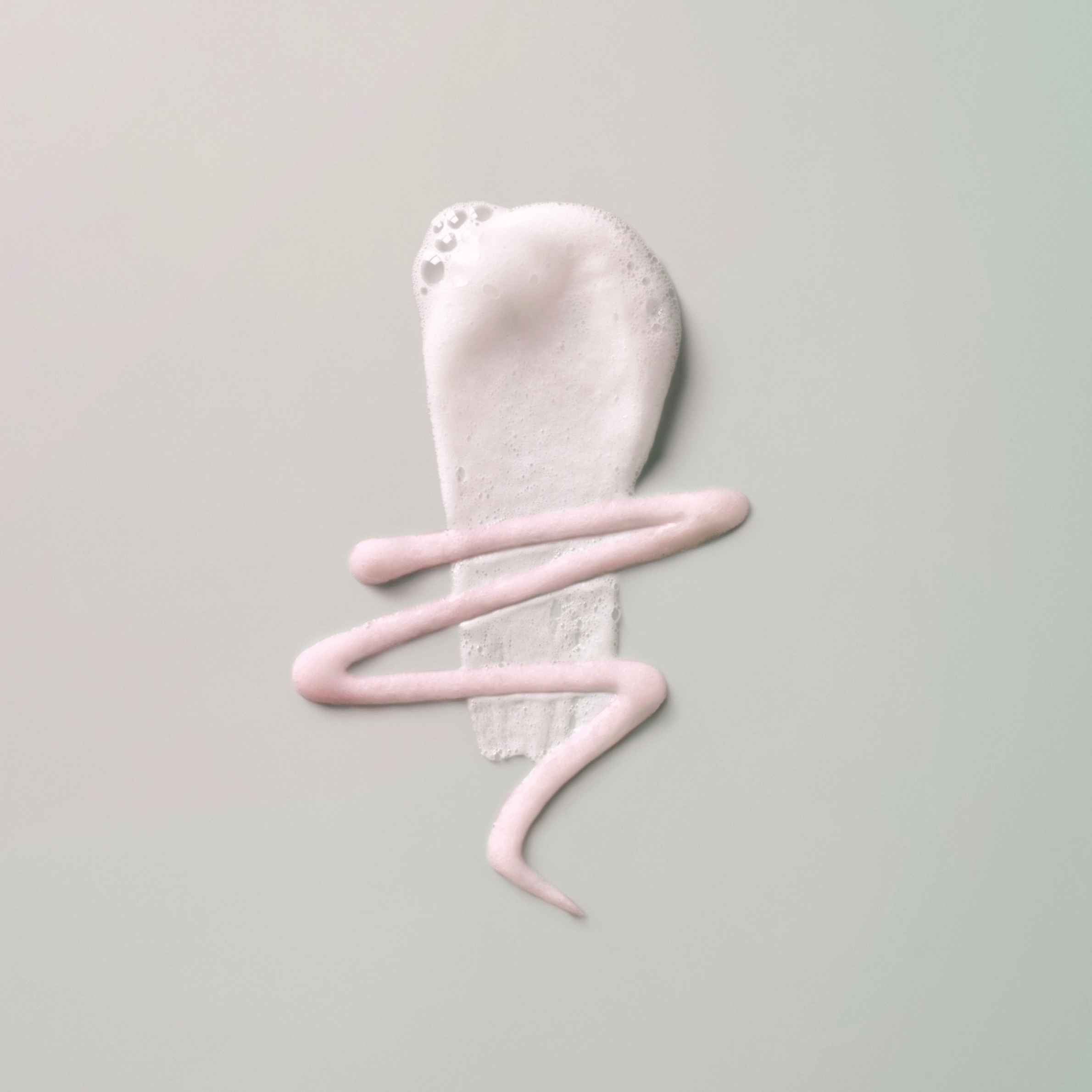 Elemis Hydrating Cleanser texture shot on grey background