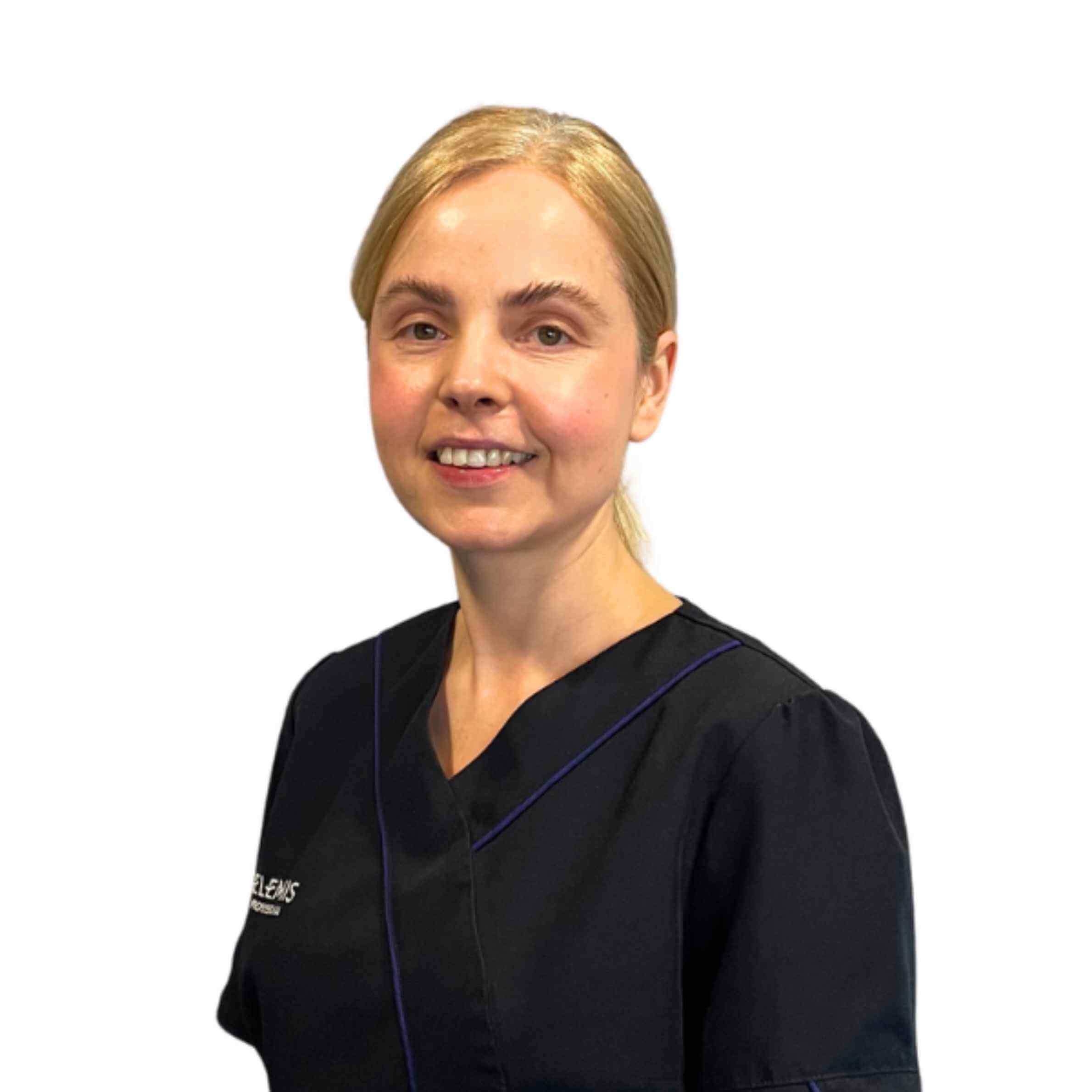 Person wearing a black scrub top with a visible brand logo on a white background