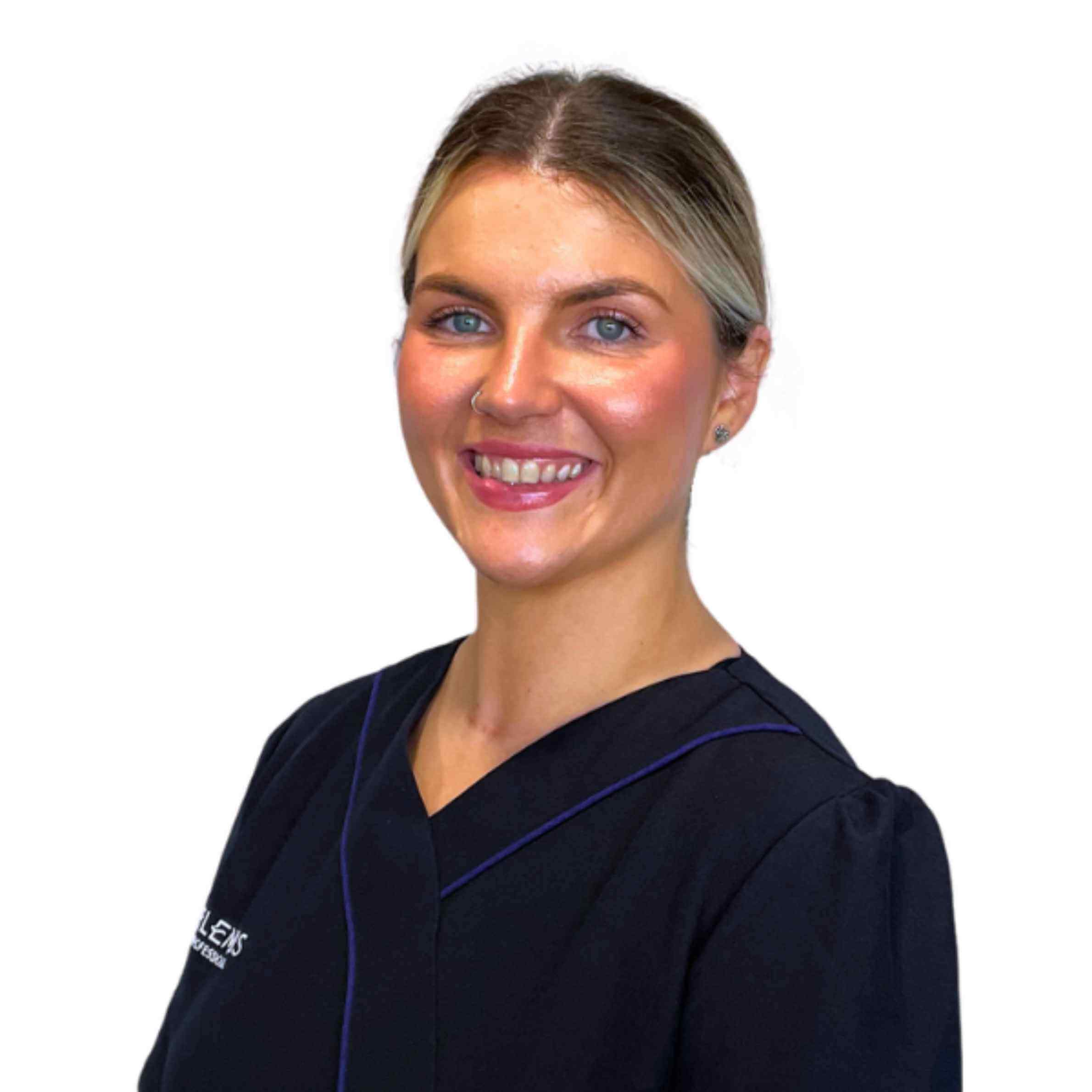 Woman wearing a dark blue scrub top with a visible brand logo on a white background
