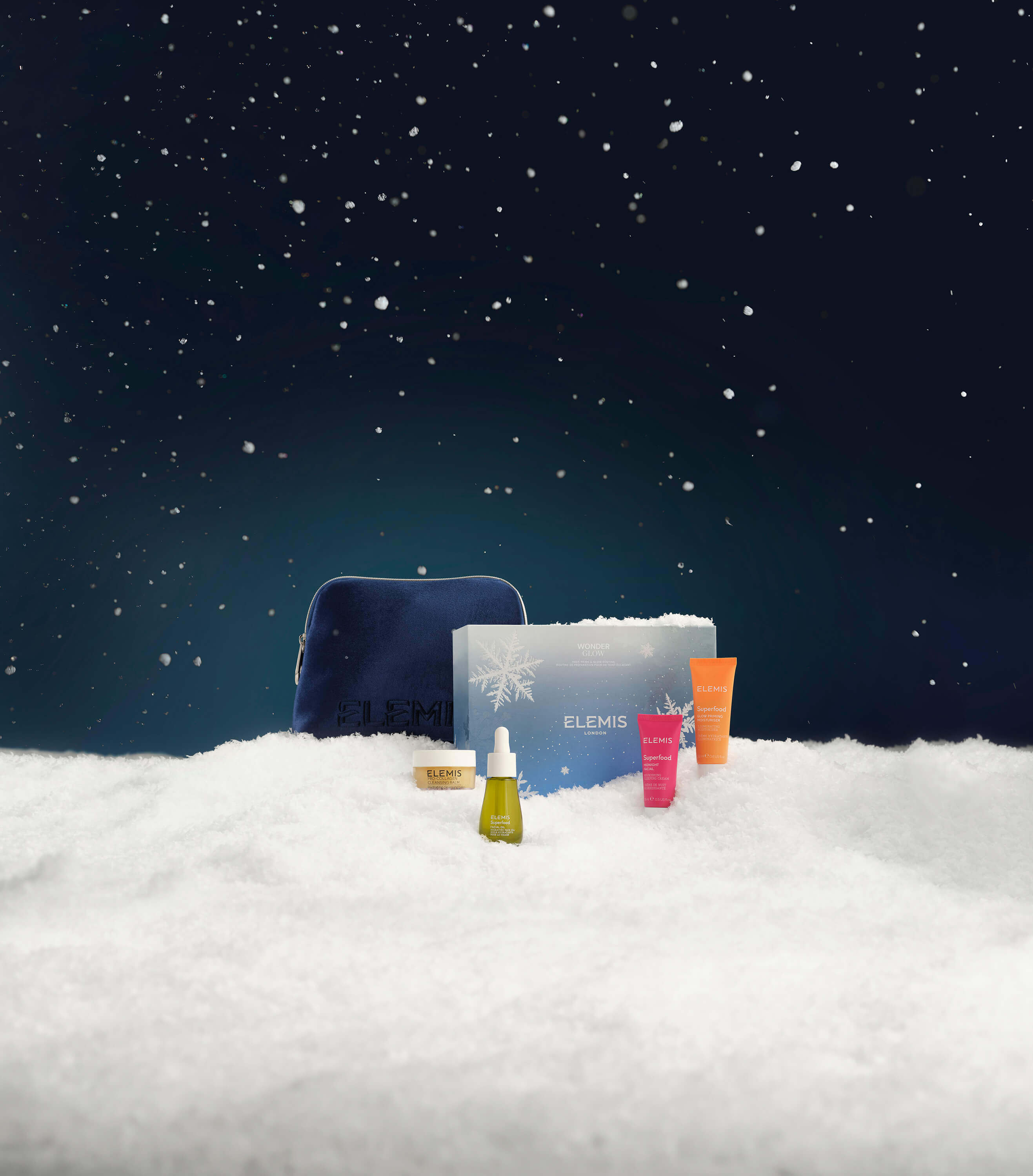 Cosmetic set with Elemis branding on a snowy landscape at night