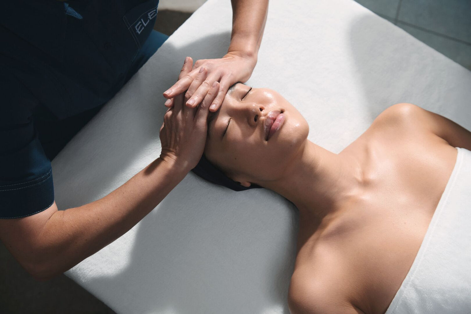 Person receiving a head massage in a spa setting