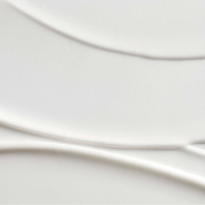 A close-up of a smooth, glossy white ceramic surface with subtle curved lines and soft shadows.