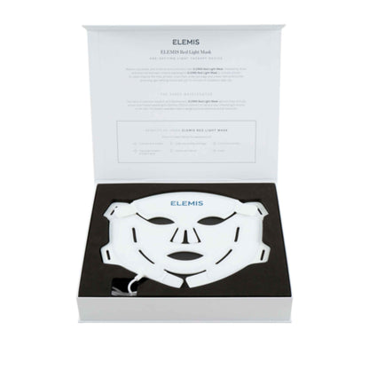 A white Elemis LED light therapy face mask presented inside its open white and black gift box, with the product name and description printed on the inside lid.