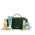 ELEMIS skincare set featuring jars, bottles and tubes, in front of a dark emerald green travel bag with gold detailing.